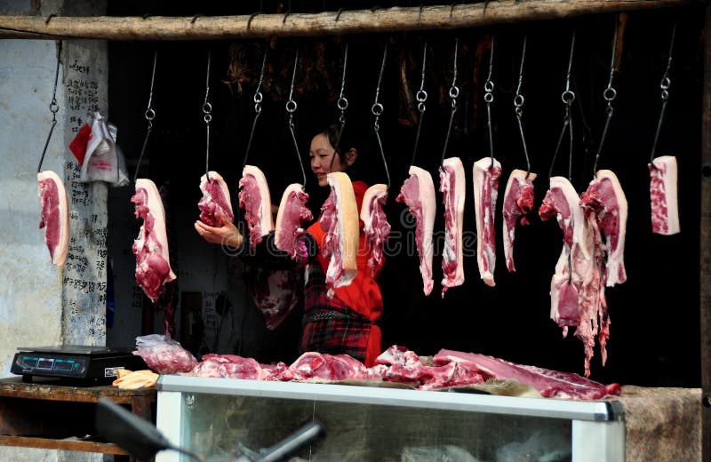 Pengzhou, China: Pork on Hooks at Butcher Shop royalty free stock images