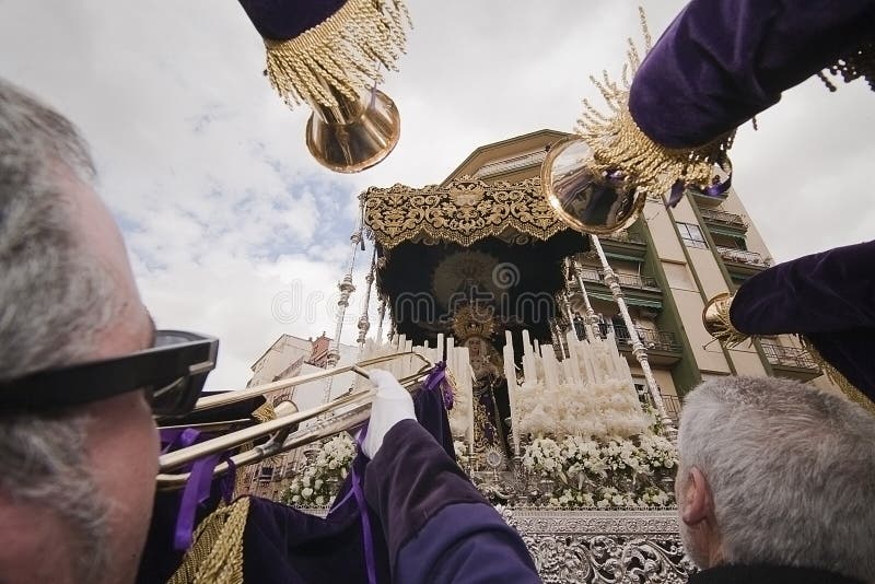 Penitents touch large trumpets to Virgen de los Dolores in a procession of holy week