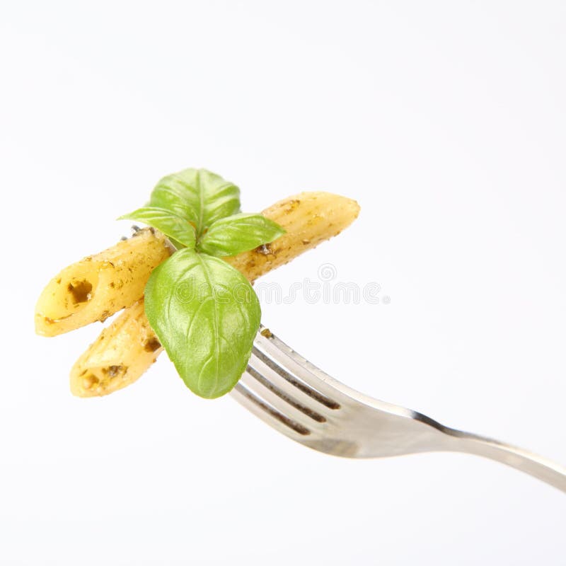 Penne with pesto on a fork
