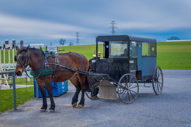 Pennsylvania, USA, APRIL, 18, 2018: Outdoor view of parked Amish buggy carriage in a farm with a horse used for a pull royalty free stock photography Pennsylvania, USA, APRIL, 18, 2018: Outdoor view of parked Amish buggy carriage in a farm with a horse used for a pull royalty free stock photography