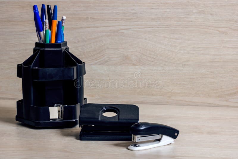 Pens and pencils in the stand, stapler and hole punch stock photos