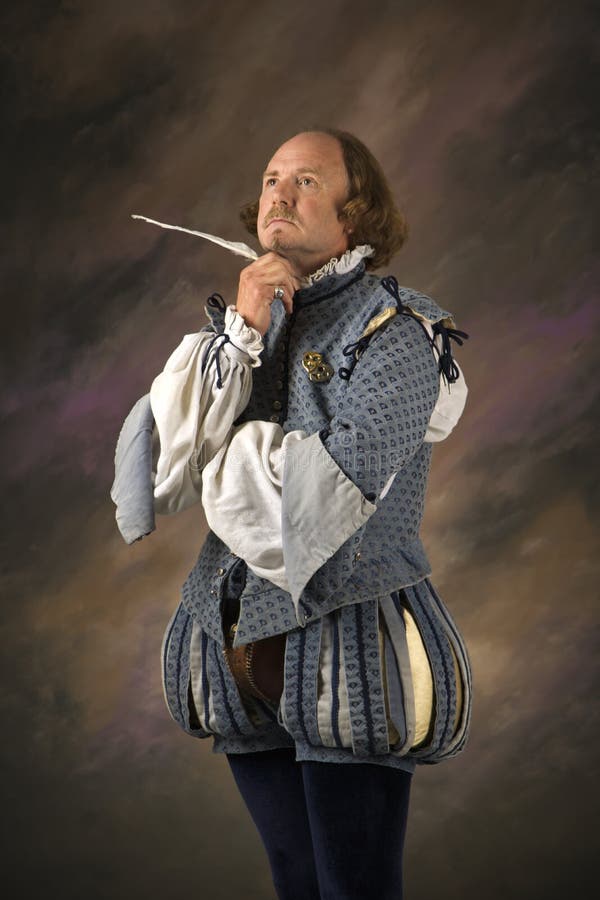 William Shakespeare in period clothing holding feather pen with thoughtful expression. William Shakespeare in period clothing holding feather pen with thoughtful expression.