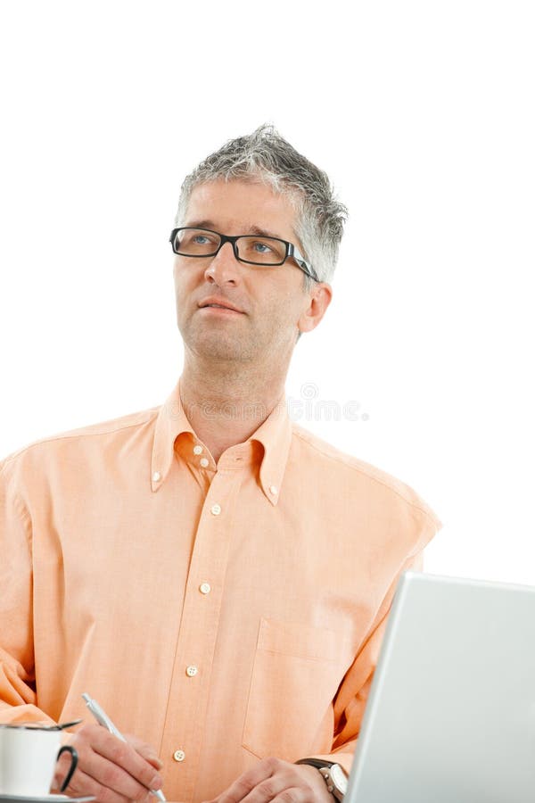 Casual businessman wearing orange shirt and jeans, thinking abouth something and writing notes. Isolated on white. Casual businessman wearing orange shirt and jeans, thinking abouth something and writing notes. Isolated on white.