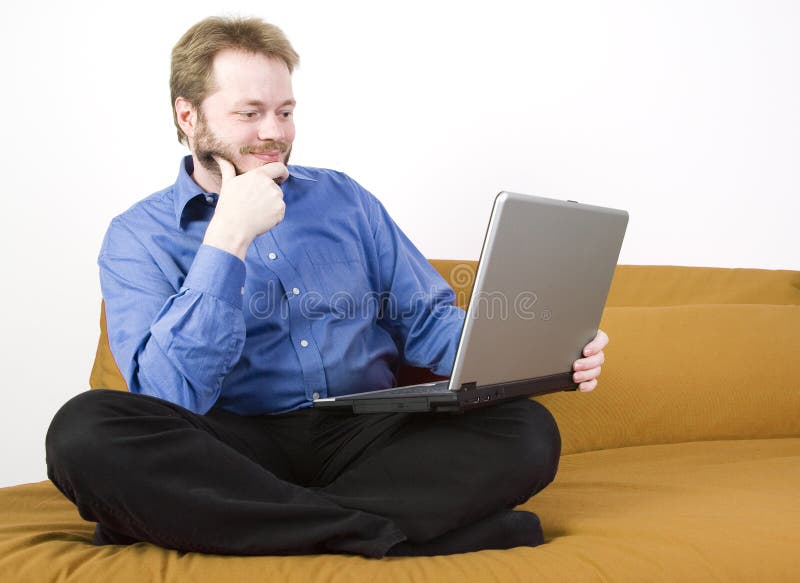 Casual businessman with laptop working on a couch. Casual businessman with laptop working on a couch.