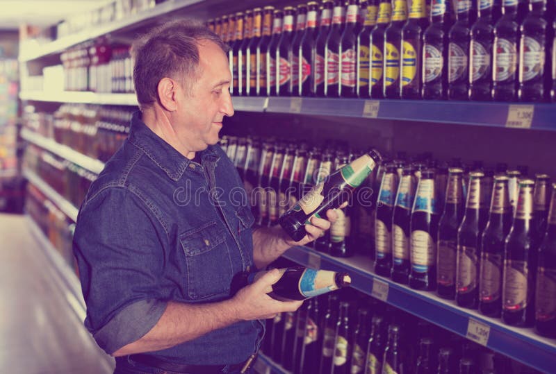 Pensioner Selecting a Beer at the Store Stock Photo Image of indoor