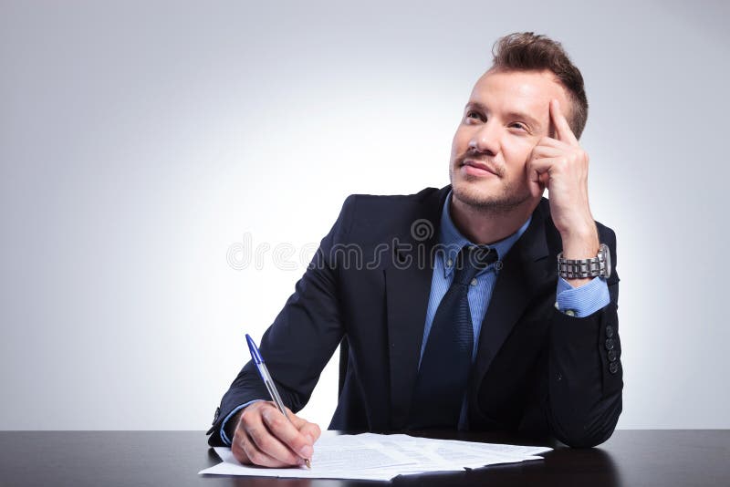 Pensive business man writes a letter royalty free stock images Pensive business man writes a letter royalty free stock images