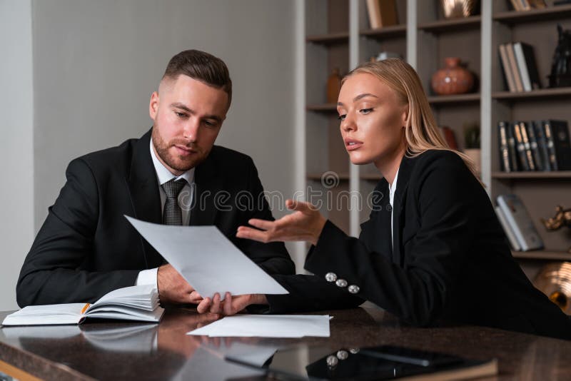 Pensive businessman and businesswoman working together with documents royalty free stock photos