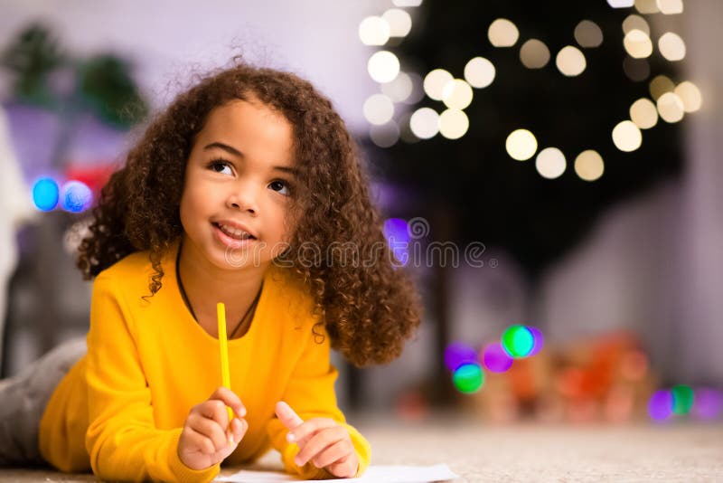 Pensive cute little afro girl thinking about gift ask from Santa royalty free stock photos Pensive cute little afro girl thinking about gift ask from Santa royalty free stock photos
