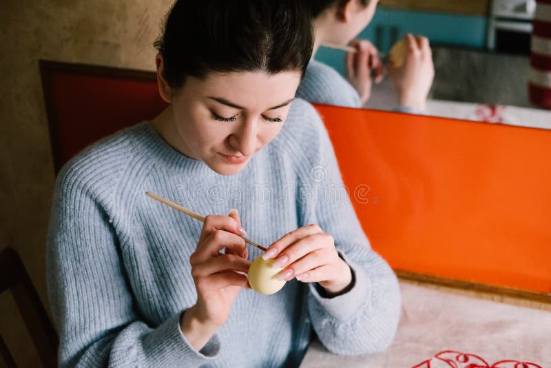 Pensive millennial girl painting Easter egg at homeapril,art,arts and culture,blue,body part,brush,caucasian,color,craft,creative, stock photo Pensive millennial girl painting Easter egg at homeapril,art,arts and culture,blue,body part,brush,caucasian,color,craft,creative, stock photo