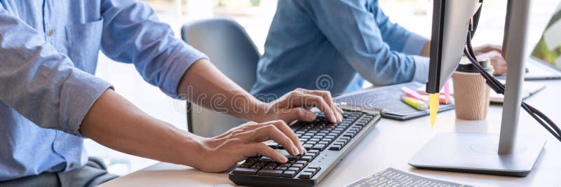 Pensive programmer working on on desktop pc programming code technologies or website design at office Software Development Company royalty free stock image