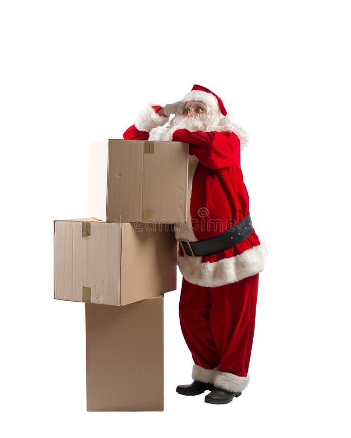 Pensive santa claus thinks about the delivery of christmas boxes stock image