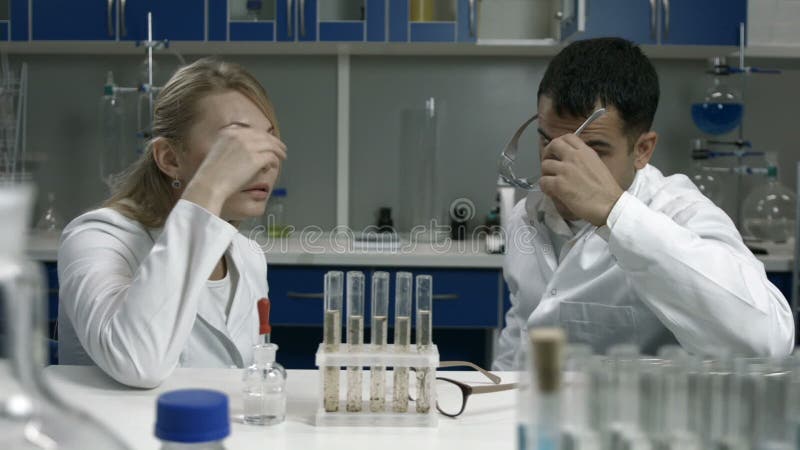 Pensive scientists thinking over bad results