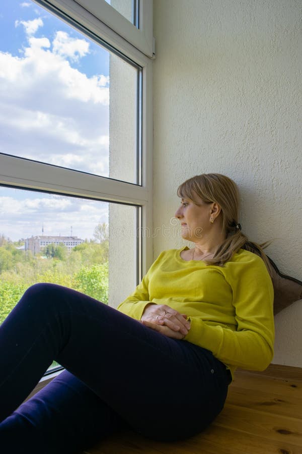 The Man Looks Outside Standing At The Open Window Of His Apartment Staying  At Home During The Epidemic And Quarantine Stock Photo - Download Image Now  - iStock