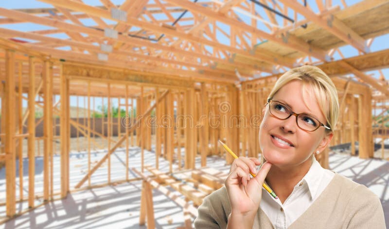 Pensive Woman with Pencil On Site Inside New Home Construction F