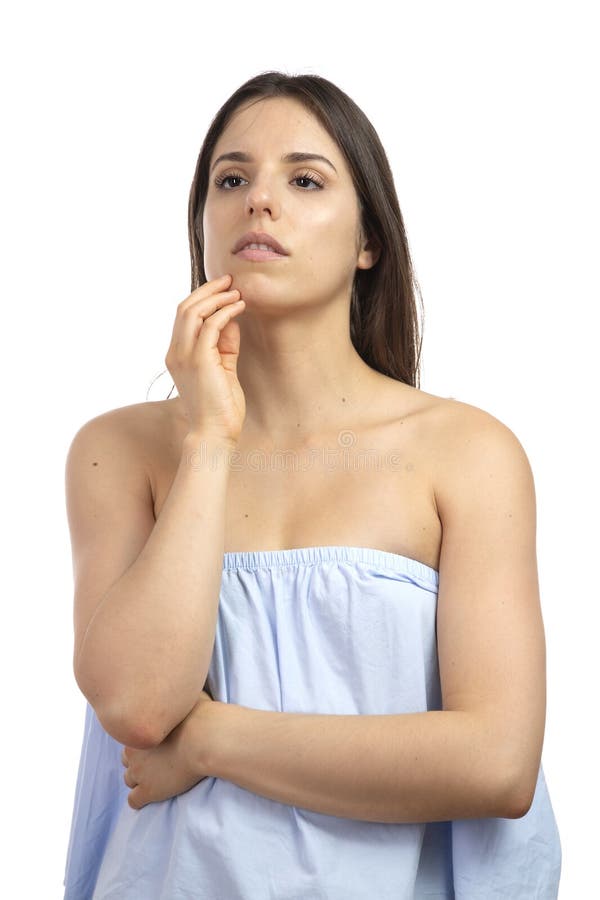 Pensive young girl posing on a white background. stock image