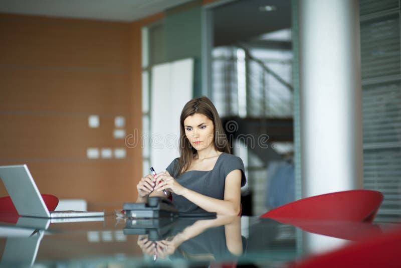 Pensive young woman at work