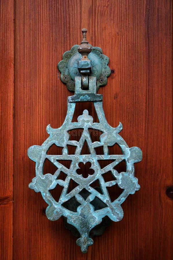 Pentagram knocker on a wooden door