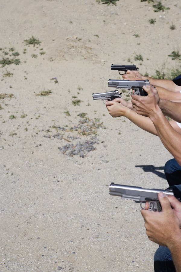 Man with Hand Gun Jumping Obstacle at Firing Range Stock Photo Image