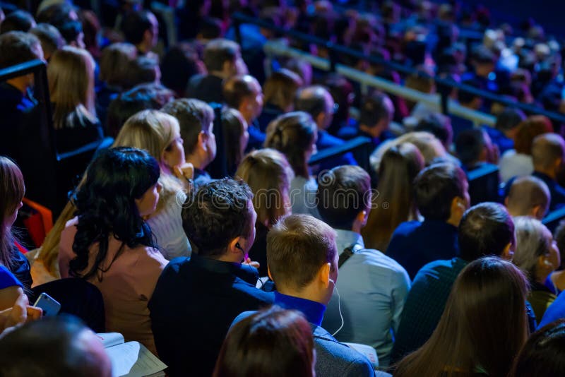 People attend business conference in congress hall