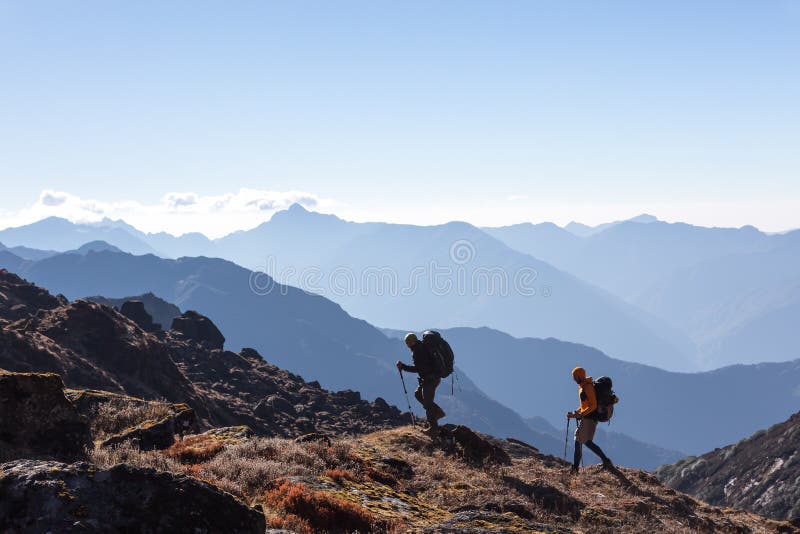 People with Backpacks and trekking Sticks traveling in Mountains stock images People with Backpacks and trekking Sticks traveling in Mountains stock images