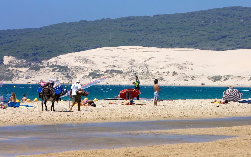 People on busy active kitesurfing beach in Spain