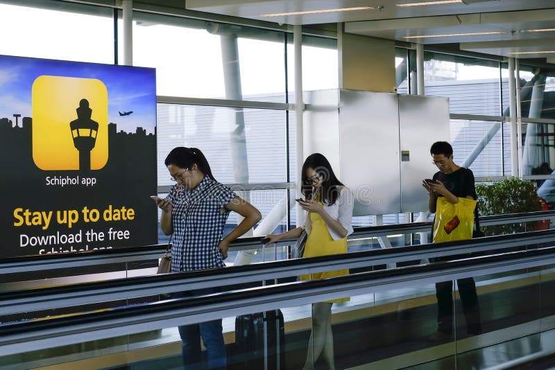 People checking smartphone at airport