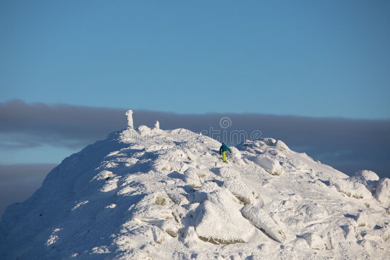 People climbing to the top of snowed mountains peak