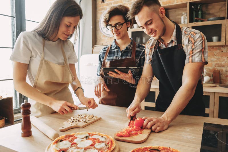 People cooking together. Company of friends chopping ingredients.