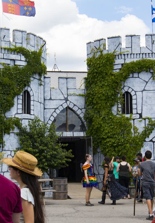 People in costume gathered around the castle entrance including a girl dressed as a rainbow fairy at the Renassiance Festival in M royalty free stock photos People in costume gathered around the castle entrance including a girl dressed as a rainbow fairy at the Renassiance Festival in M royalty free stock photos