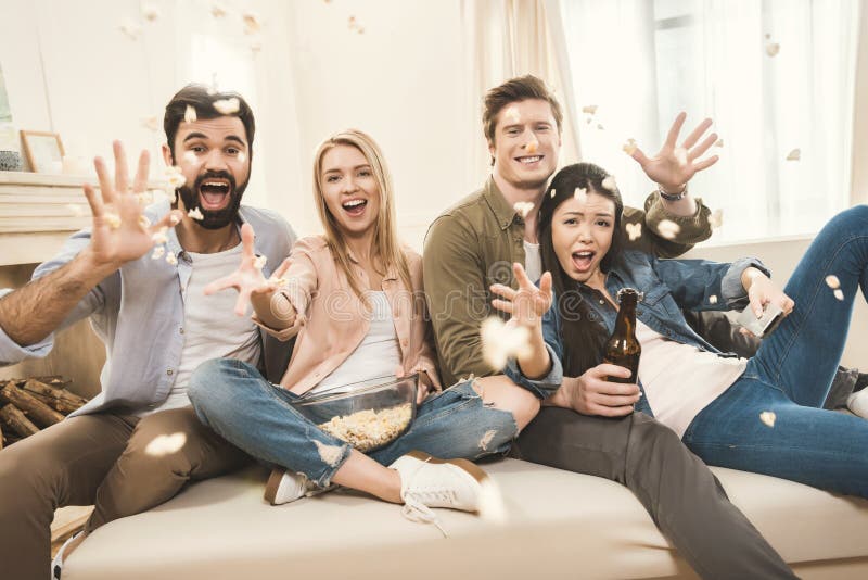 People on Couch Throwing Popcorn Upside Stock Image Image of laughing
