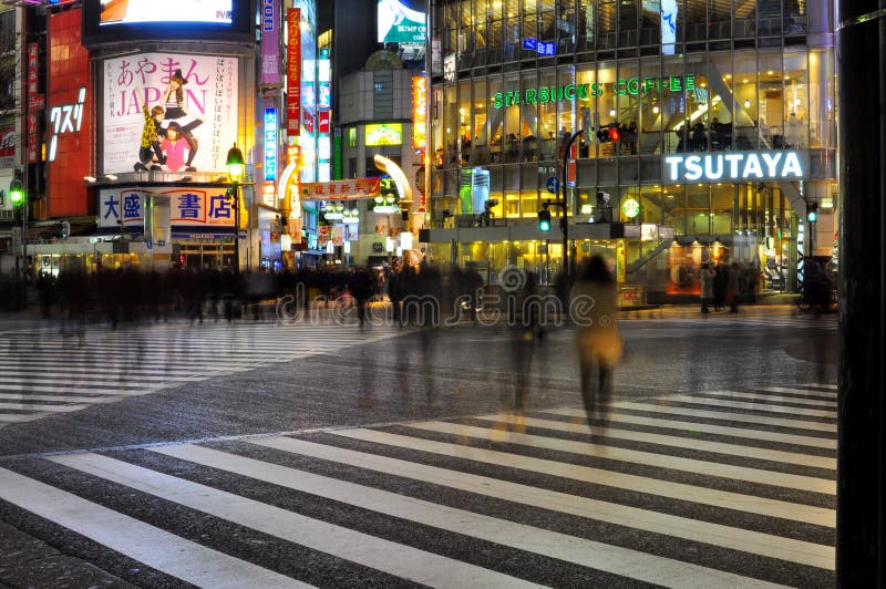 People cross the street in shibuya , tokyo , japan