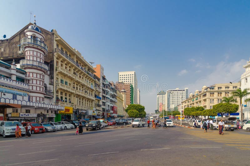 People crossing on the busy street of downtown Yangon stock photo People crossing on the busy street of downtown Yangon stock photo