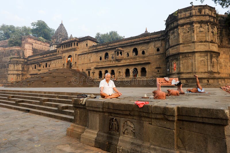 People doing yoga and meditation in front of Maheshwar palace