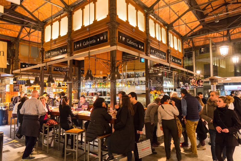 People drinking and eating at San Miguel market, Madrid.