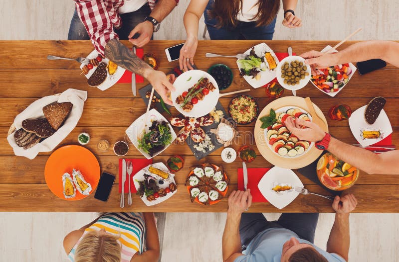 People Eat Healthy Meals at Festive Table Dinner Party Stock Photo