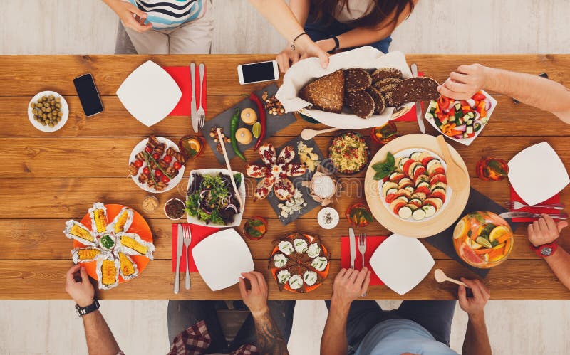 People Eat Healthy Meals at Served Table Dinner Party Stock Photo