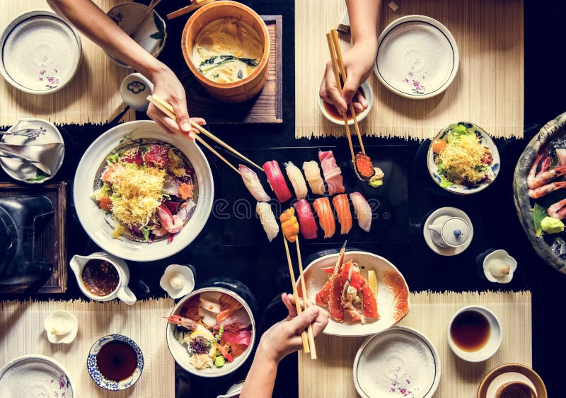 People eating Japanese food together stock images