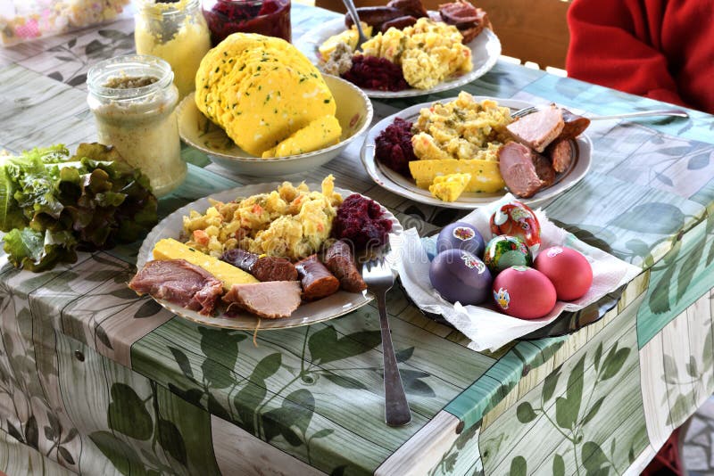 People eating traditional easter food with salad, ham eggs, beetroot and horseradish