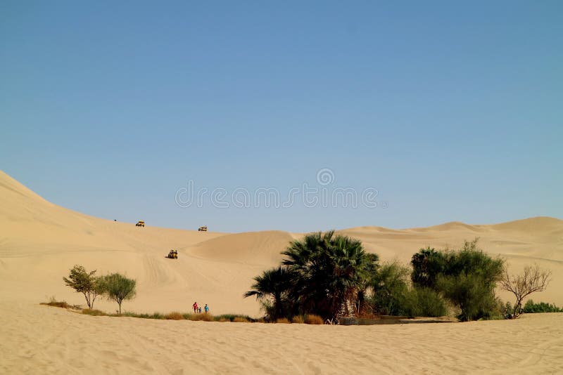 People enjoy the activities around the small oasis on the immense sand dunes of Huacachina desert, Ica region, Peru royalty free stock photos People enjoy the activities around the small oasis on the immense sand dunes of Huacachina desert, Ica region, Peru royalty free stock photos
