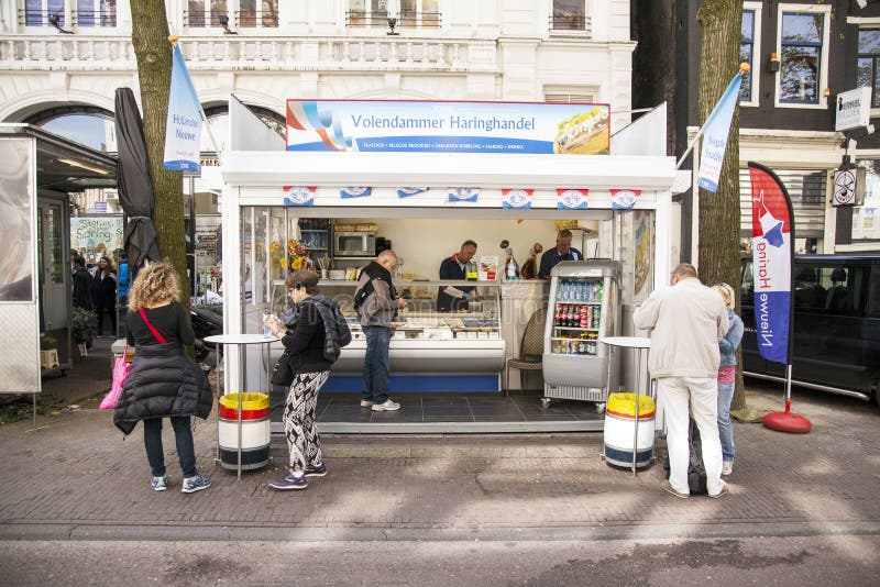 People Enjoy Fresh Herring at Stall in Centre of Amsterdam Editorial