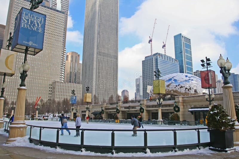 CHICAGO,IL-FEB 09:Unidentified people enjoy ice skating near Skygate Bean against high building towers and blue sky at Millennium Park on February 09, 2008 in Chicago, IL USA. CHICAGO,IL-FEB 09:Unidentified people enjoy ice skating near Skygate Bean against high building towers and blue sky at Millennium Park on February 09, 2008 in Chicago, IL USA.