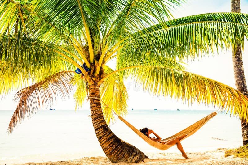 People enjoy vacation on tropical sandy beach on background sea water and blue sky