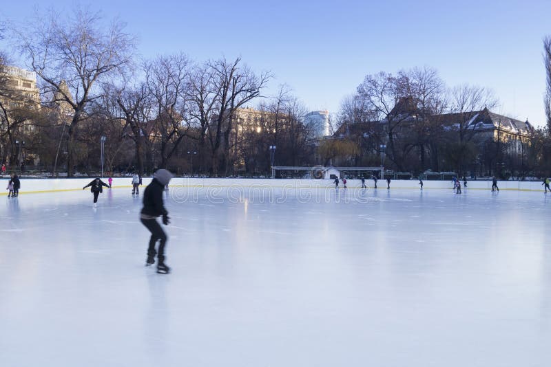 People enjoying ice skating rink stock images