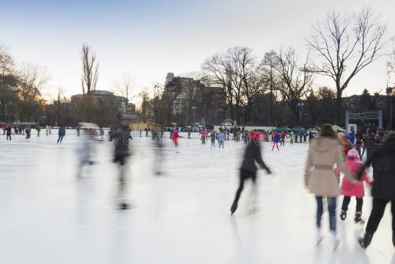People enjoying ice skating rink royalty free stock image