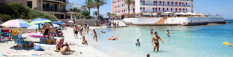 People in Es Trenc beach with white sand and turquoise sea