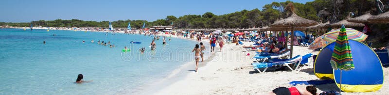 People in Es Trenc beach with white sand and turquoise sea