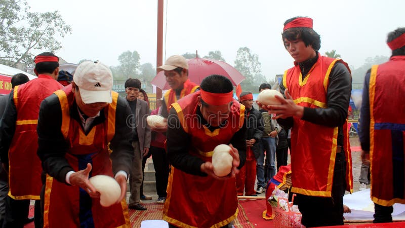 People exam to make round sticky rice cake. HAI DUONG, VIETNAM, February, 21:People exam to make round sticky rice cake at Cao festival on February, 21, 2014 in royalty free stock image People exam to make round sticky rice cake. HAI DUONG, VIETNAM, February, 21:People exam to make round sticky rice cake at Cao festival on February, 21, 2014 in royalty free stock image