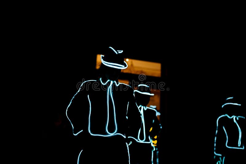 People in glowing costumes dancing in the dark stock images People in glowing costumes dancing in the dark stock images