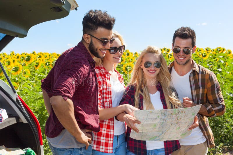 People group looking road map standing sunflowers field outdoor