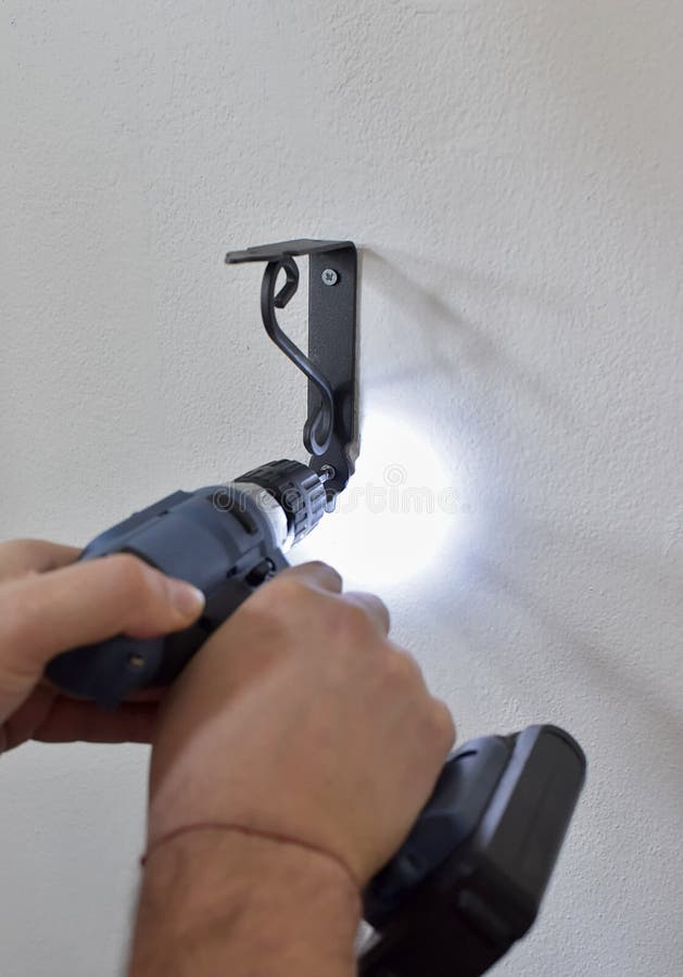 People Hand Drilling into Apartment Wall with Cordless Drill. Stock